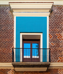 Balcony window with brick facade, Puebla, Mexico.