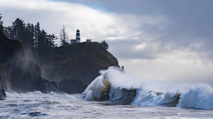 Huige waves crashing on the headland under Cape Disapointment lighthouse near the mouth of the Columbia River, Ilwaco, Washington © Bob