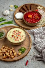 Beetroot red Ukrainian borsch and creamy chicken soup with grilled vegetables. Balanced tasty diet food. First course