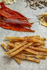 Snacks for beer. Assorted salted, dried and dried fish: horse mackerel, squid, tuna, smelt and capelin. Octoberfest party dinner. Festive table with delicious food.