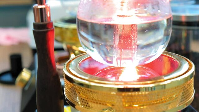 Beautiful coffee americano makes a barista in a gabe siphon in a cafe close-up, general plan