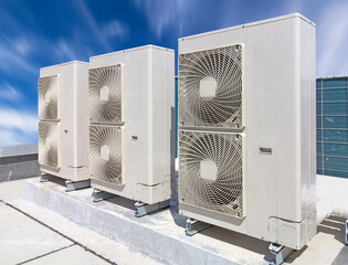 Condenser unit or compressor on roof of industrial plant building with sky background. Unit of...
