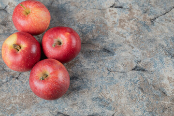 Red apples isolated on a concrete background