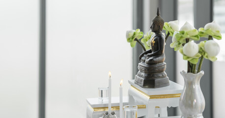 metal buddha statue on altar shelf at home for buddhist people worship and chanting