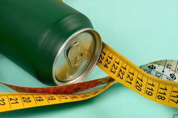 Green aluminum drink can with colorful measuring tape