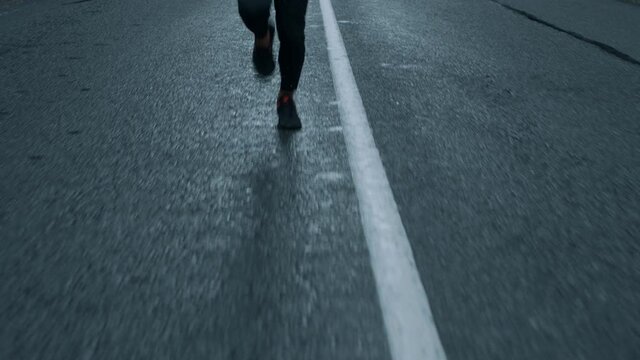 A man running in the middle of the road.
