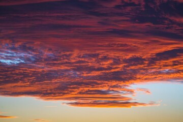 This image showcases a sunset sky illuminating colorful clouds.