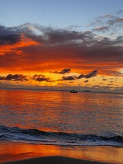 Sunset at the beach whit a boat, Beautiful sunrise and dramatic clouds on the sky. Flood waters of river. Wallpaper.