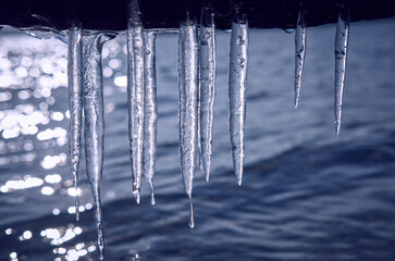 Icicles hanging over the water