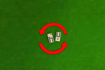 Two rounded arrows red, two knuckles of the game dominoes in white on a green background.  Logic, thinking.