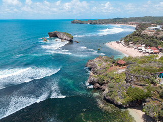 Fototapeta premium Aerial view of Beautiful beach in Gunung Kidul, Indonesia in daylight.