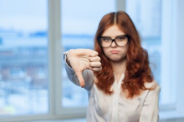 Fototapeta premium pretty woman with glasses gesturing with hands emotions office work as a manager