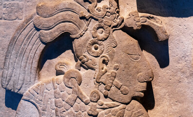 Bas relief carving in a tombstone of a mayan ruler king in Mexico City, Mexico. Focus on nose and...