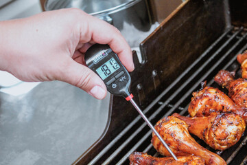 Gatineau, Quebec Canada - July 18, 2020: A food thermometer checking that chicken is being cooked...