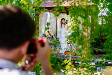 bride with bouquet of lilies kalla in a gazebo. backstage wedding photo shoot