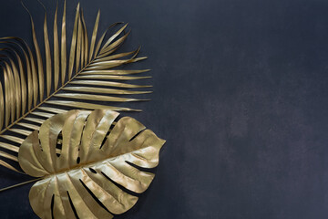 Collection of tropical leaves in gold color on black space background.Abstract leaf decoration design.