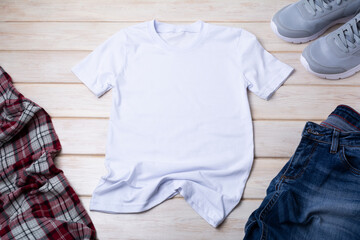 Men’s T-shirt mockup with indigo jeans and gray running shoes