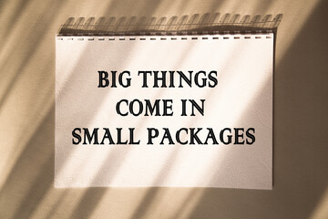 BIG THINGS COME IN SMALL PACKAGES. Saying. expression written on a notepad