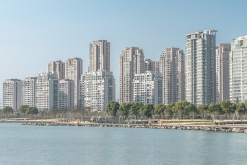 Fototapeta na wymiar Modern residential skyscrapers in Suzhou, along a lake.