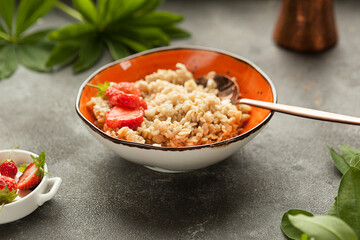 oatmeal or wheat porridge for breakfast with strawberries, traditional Russian breakfast