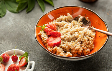 oatmeal or wheat porridge for breakfast with strawberries, traditional Russian breakfast