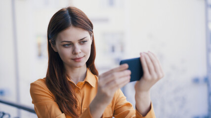 pretty woman with phone in hands outdoors photography technology