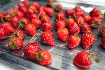 Bright red strawberry on a white table