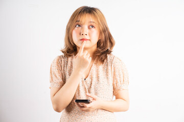 Young asian girl holding phone with expressions, gestures on background