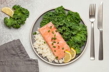 Steam salmon with rice and salad Kale in a plate on the table. Diet nutrition. Top view