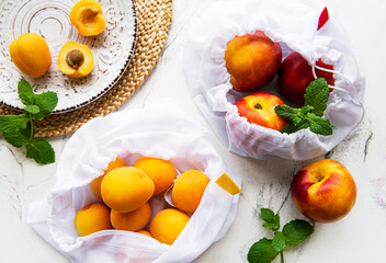 Peaches and apricots in eco bags.