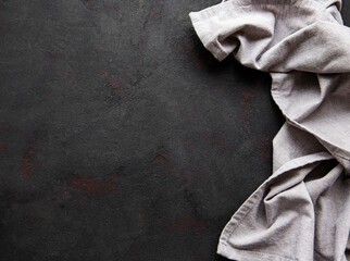 Grey linen tablecloth on a black background countertops.