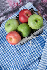 Apples in a basket covered with white towel