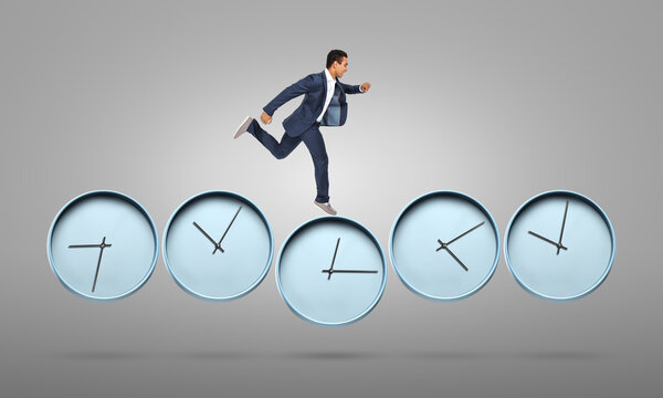 Running African-American businessman with clocks on grey background. Deadline concept