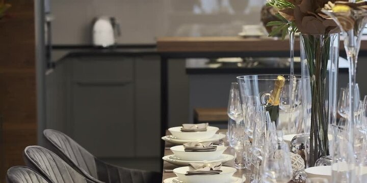 Banquet table set with glasses for an event party or wedding arrangement at home kitchen. Mssp Decorated table on a dinner party with wine glasses and blurred out background. Served celebration.