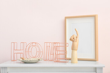 Wooden hand with stylish decor on table in interior of room