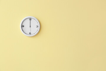 Fototapeta na wymiar Stylish clock hanging on color wall