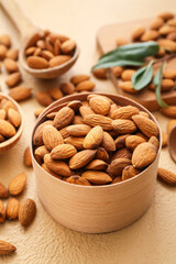 Box with healthy almonds on color background