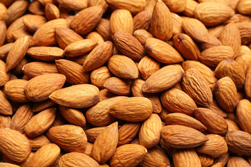 Fototapeta premium Heap of tasty almonds as background