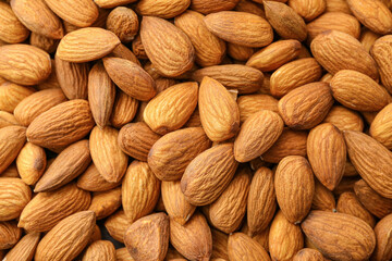 Heap of tasty almonds as background
