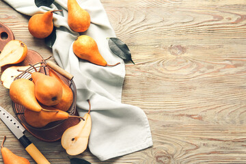 Fresh ripe pears on wooden background