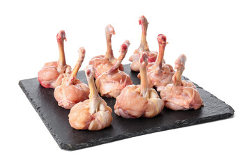 Plate with raw chicken lollipops on white background