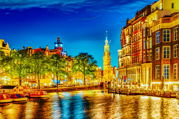 Famous Amstel river and night view of beautiful Amsterdam city. Netherlands