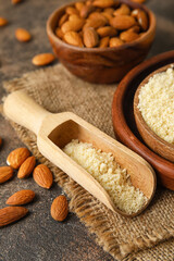 Scoop with almond flour on dark background