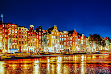 Fototapeta na wymiar Famous Amstel river and night view of beautiful Amsterdam city. Netherlands