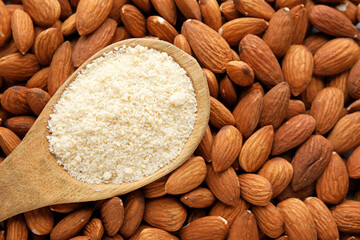 Spoon with almond flour and nuts, closeup