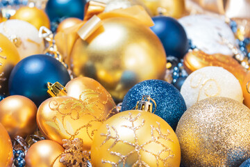 Amazing Christmas composition with blue and gold christmas balls. Christmas or New Year concept. Dark festive background with baubles. Top view. Close up. 