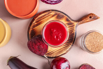 Glass of healthy smoothie and vegetables on color background