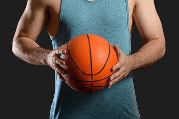 Male basketball player on dark background