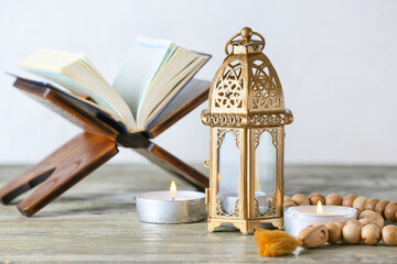 Muslim lamp, tasbih and Koran on table