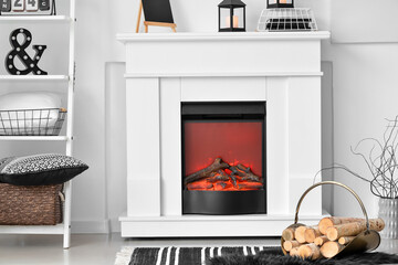 Stylish mantelpiece with firewood on interior of living room